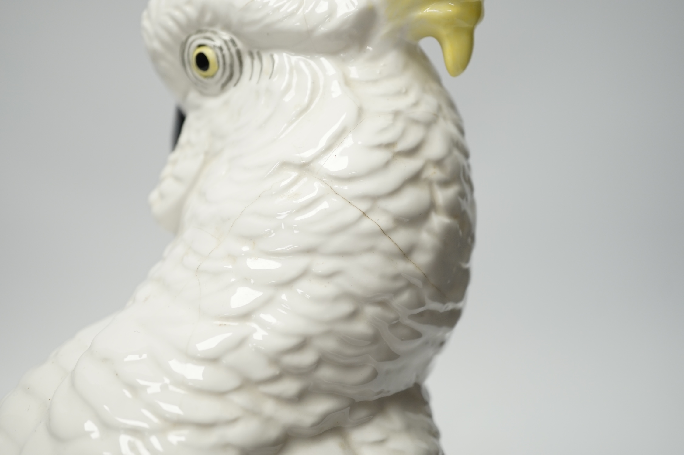 A Doulton and Slater’s patent stoneware vase and a Royal Staffordshire porcelain figure of a cockatoo, 33cm high. Condition - poor to fair condition, significant cracks to cockatoo